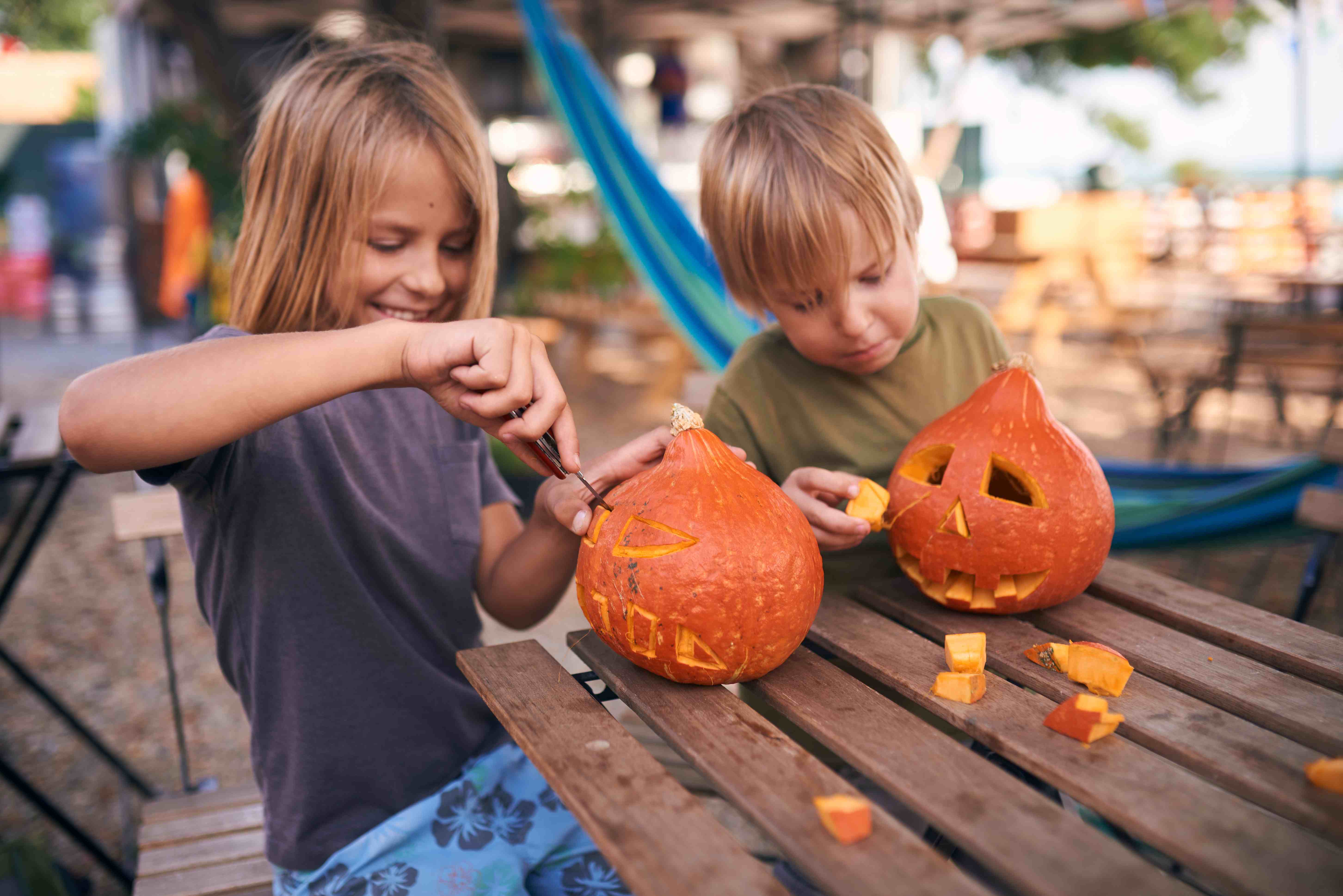 children carving pumpkins